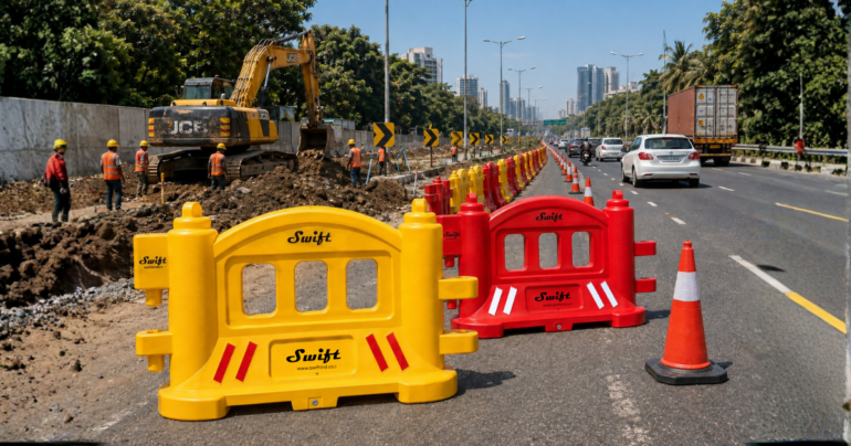 Swift yellow and red water-filled road safety barriers at a highway construction site with traffic cones and workers.