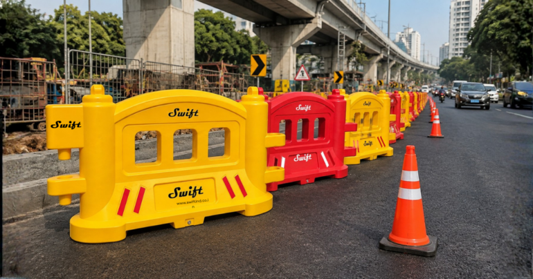 Swift yellow and red road safety barriers along a highway construction zone with traffic cones and elevated metro infrastructure.