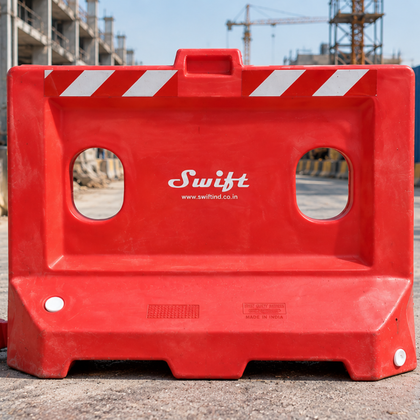 Red plastic road safety barricades installed on an urban road for traffic control