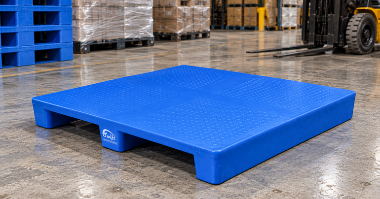 Blue 2 Way Entry Non Reversible Plastic Pallet in an industrial warehouse